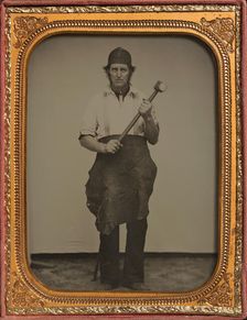 Man Gripping Sledgehammer, Wearing Leather Half Apron and Cap, 1850s-60s. Creator: Unknown