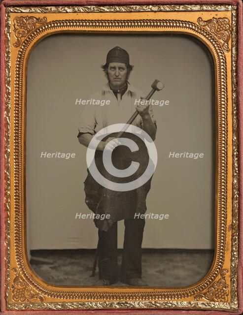 Man Gripping Sledgehammer, Wearing Leather Half Apron and Cap, 1850s-60s. Creator: Unknown.
