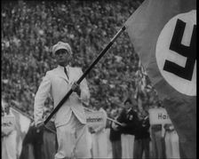 Man Holding the Flag of Nazi Germany, 1936. Creator: British Pathe Ltd