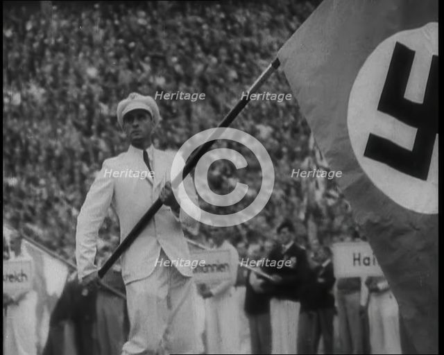 Man Holding the Flag of Nazi Germany, 1936. Creator: British Pathe Ltd.