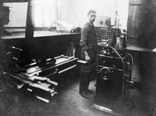 Man in a printing workshop, (late 19th-early 20th century?). Creator: W Martin