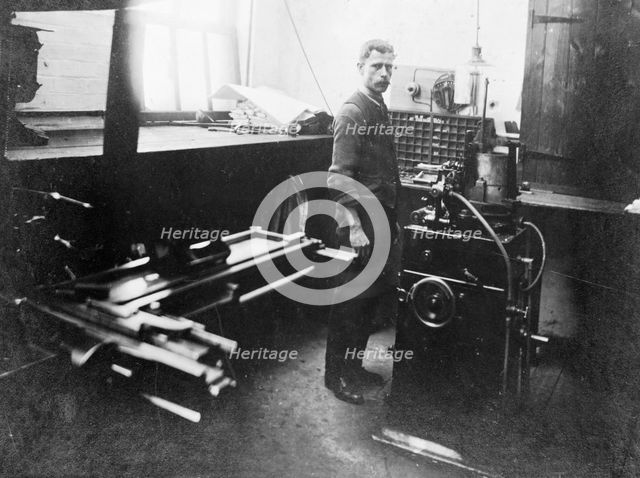 Man in a printing workshop, (late 19th-early 20th century?). Creator: W Martin.