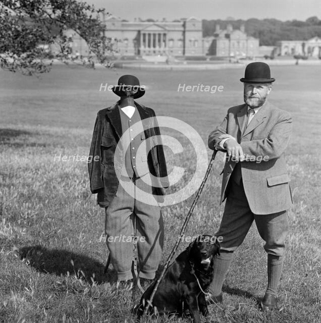 Man in breeches with a dog and a mannequin, Holkham Hall, Norfolk, 1978-1981. Artist: John Gay