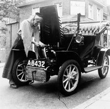 Man in fancy dress with a veteran car, London, (c1960-c1980?). Creator: Henry Grant