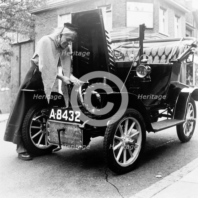 Man in fancy dress with a veteran car, London, (c1960-c1980?). Creator: Henry Grant.
