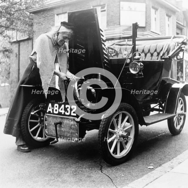 Man in fancy dress with a veteran car, London, (c1960-c1980?). Artist: Henry Grant