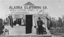 Man in front of Alaska Clothing Co. store, between c1900 and 1916. Creator: Unknown