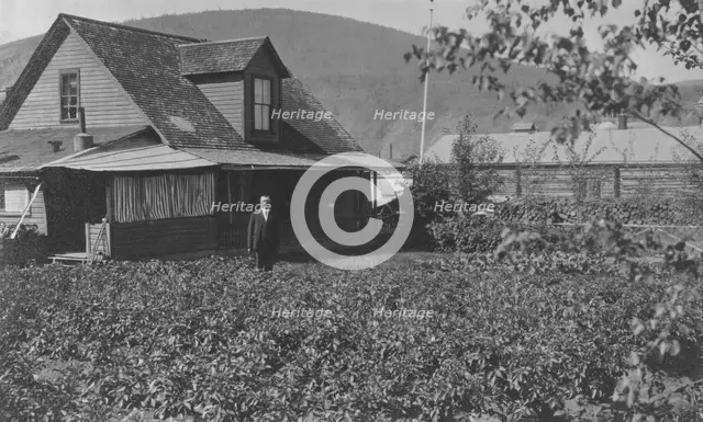 Man in frontyard of house, between c1900 and 1916. Creator: Unknown.