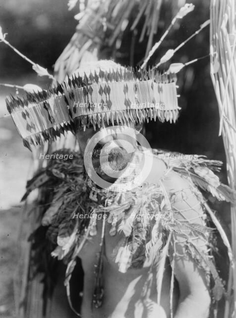 Man in Pomo dance costume, half-length portrait, facing front, c1924. Creator: Edward Sheriff Curtis.
