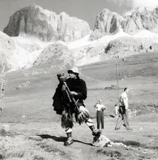 Man in traditional costume playing the zampogna (bagpipes), Sasso Pordoi, Dolomites, Italy, c1955. Creator: Arthur Charles Kirby Ware
