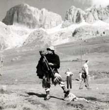 Man in traditional costume playing the zampogna (bagpipes), Sasso Pordoi, Dolomites, Italy, c1955. Creator: Arthur Charles Kirby Ware