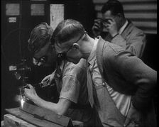 Man Inspecting an other Man Working With a Blowtorch, 1933. Creator: British Pathe Ltd