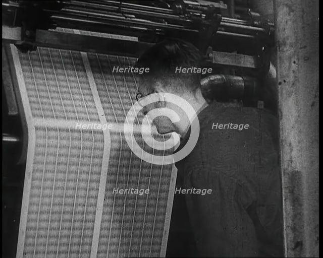 Man Inspecting Stamps Being Printed, 1936. Creator: British Pathe Ltd.