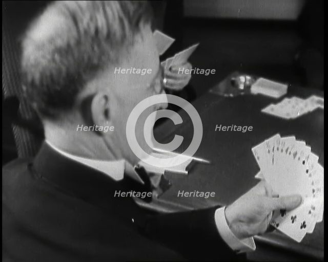 Man Playing Contract Bridge, 1930s. Creator: British Pathe Ltd.