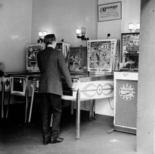 Man playing pinball in a London amusement arcade, c1966-67. Creator: Henry Grant