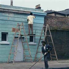 Man re-painting the exterior of a business premises in Kentish Town, London. 1960s. Artist: John Gay