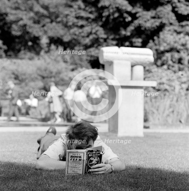 Man reading in a park, London, 1962-1964. Artist: John Gay