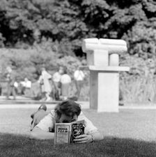 Man reading in a park, London, 1962-1964. Artist: John Gay