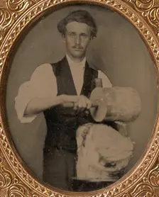 Man Riving Wood with Froe and Club, 1860s. Creator: Unknown