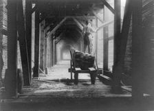 Man standing on boards on cart in sawmill and stacking the boards, Duluth vicinity, Minnesota, 1903. Creator: Frances Benjamin Johnston