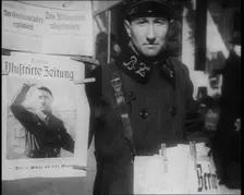 Man Standing by a Poster of Adolf Hitler, 1933. Creator: British Pathe Ltd