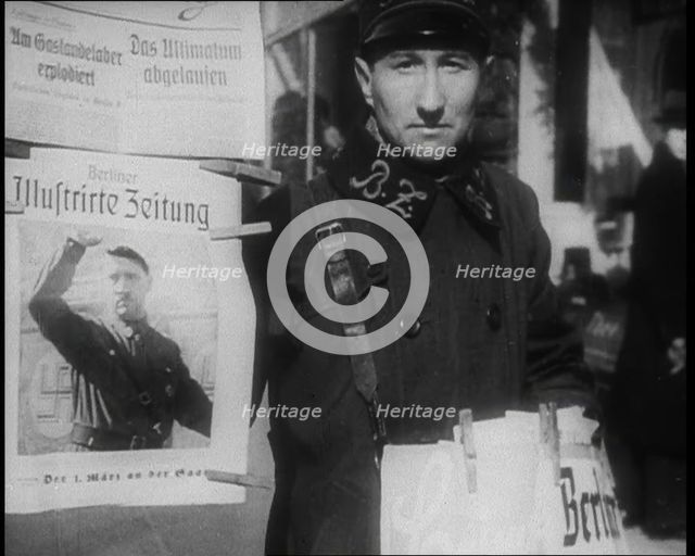 Man Standing by a Poster of Adolf Hitler, 1933. Creator: British Pathe Ltd.