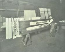 Man stencilling signs for tram cars at Charlton Central Repair Depot, London, 1932