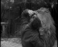 Man Sticking his Head in a Lion’s Mouth, 1930s. Creator: British Pathe Ltd