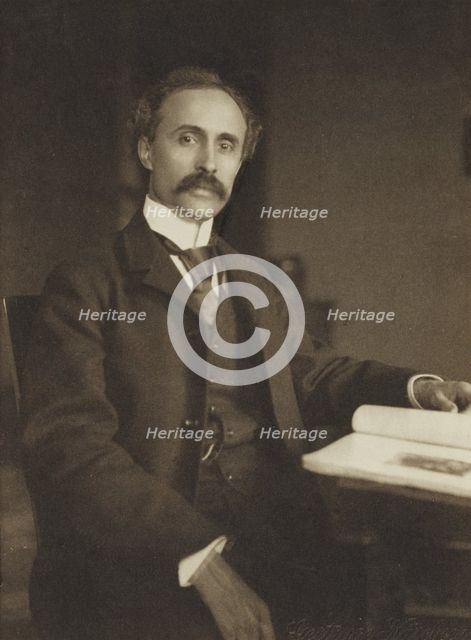 Man seated with table and book, 1896-1898. Creator: Gertrude Kasebier.