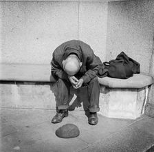Man seated on a stone bench on Blackfriars Bridge, London, c1946-c1959. Artist: John Gay