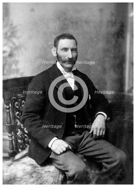 Man sitting in a chair, c1890-1909(?).Artist: Theodore Waltenberg