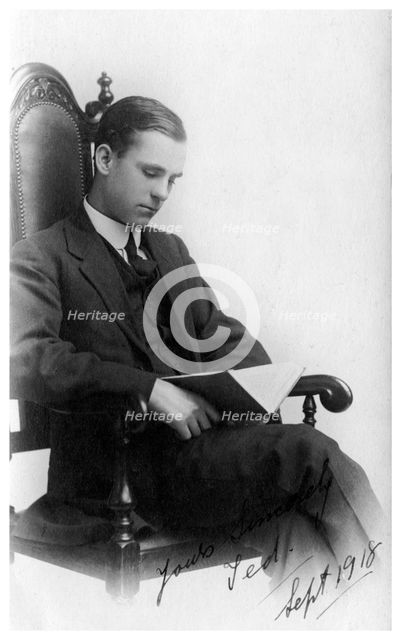Man sitting in a chair reading a book, 1918. Artist: Unknown