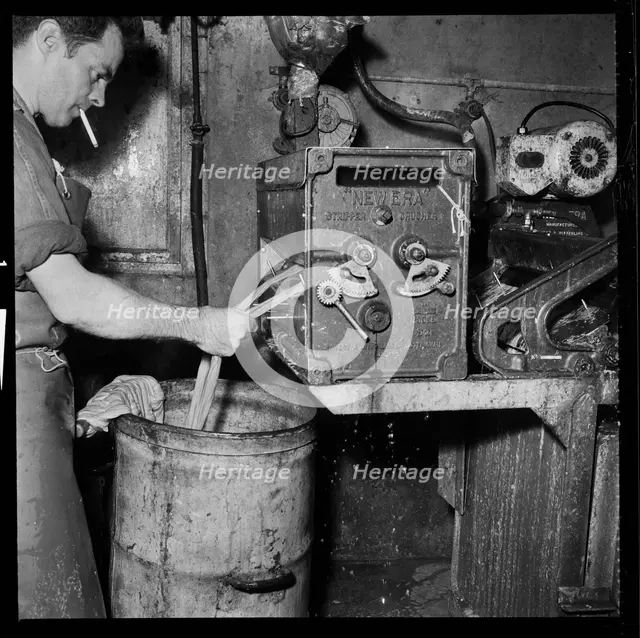 Man smoking whilst operating an Ernest A Bitterling Ltd stripper crusher machine, 1966-1974. Creator: Eileen Deste.