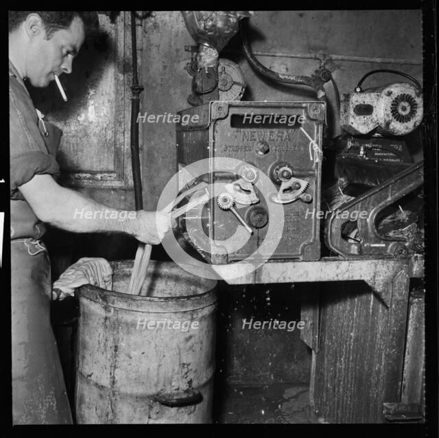Man smoking whilst operating an Ernest A Bitterling Ltd stripper crusher machine, 1966-1974. Creator: Eileen Deste.