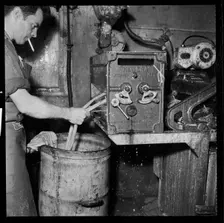 Man smoking whilst operating an Ernest A Bitterling Ltd stripper crusher machine, 1966-1974. Creator: Eileen Deste