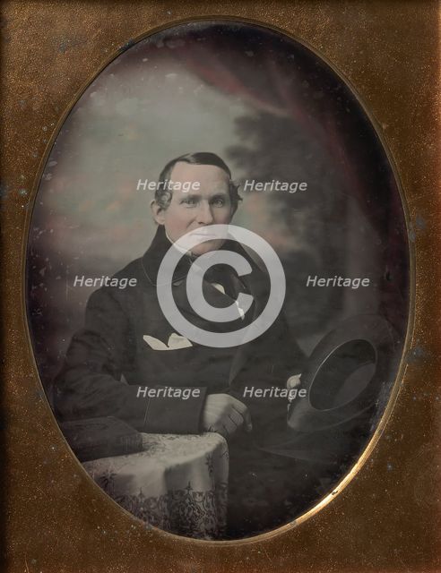 Man Wearing Coat and Gloves, Holding Hat, Seated in Front of Painted Outdoor Backdrop, 1840s. Creator: Attributed to Samuel Broadbent Jr..
