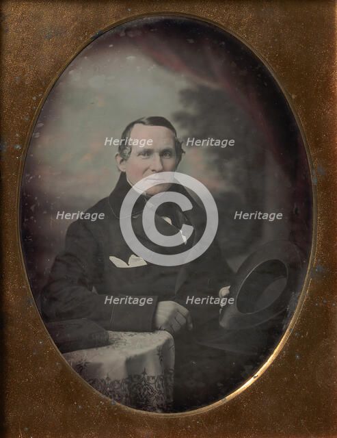 Man Wearing Coat and Gloves, Holding Hat, Seated in Front of Painted Outdoor Backdrop, 1840s. Creator: Attributed to Samuel Broadbent Jr..