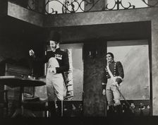 Man with a bottle and another man, 1938. Creator: Unknown