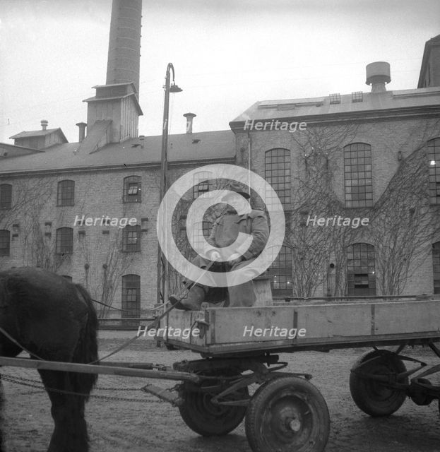 Man with a horse-drawn trailer at the sugar mill in Arlöv, Scania, Sweden, c1940s(?). Artist: Otto Ohm
