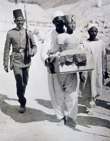 Mannequin or bust of Tutankhamun being carried from his tomb, Valley of the Kings, Egypt, 1922. Creator: Harry Burton