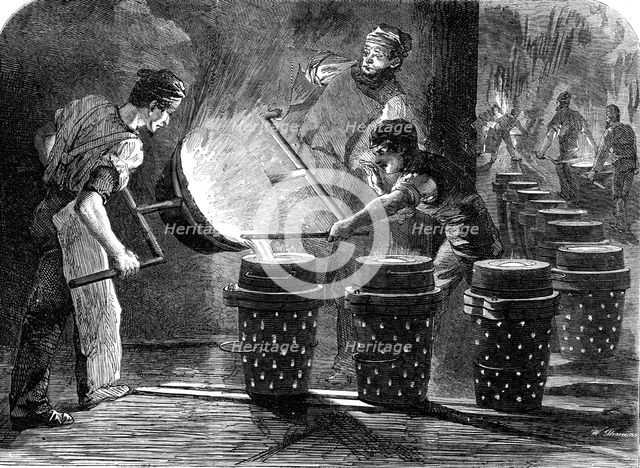 Manufacture of the Armstrong Gun at Woolwich Arsenal: casting the shot and shell for 100..., 1862. Creator: W Thomas.