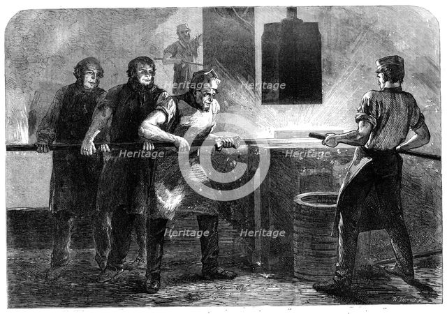 Manufacture of the Armstrong Gun at Woolwich Arsenal: drawing down and welding the..., 1862. Creator: W Thomas.