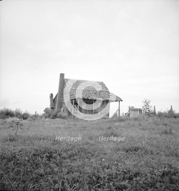 Many cabins of this type are found on the Mississippi Delta, 1936. Creator: Dorothea Lange.