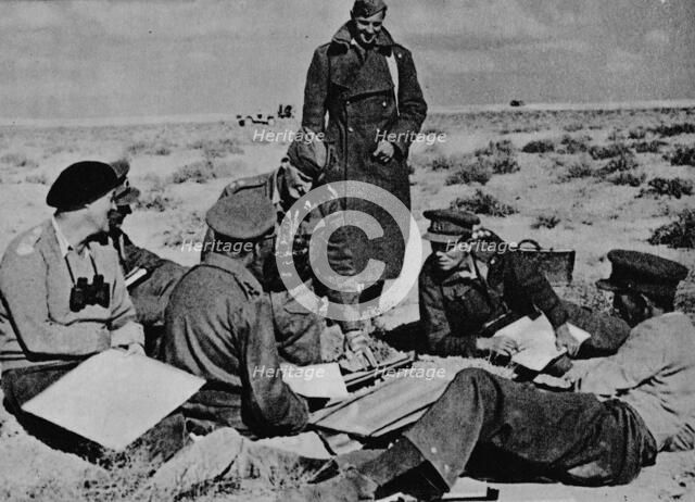 'Maps and plans are spread on the sand', 1942 (1944). Artist: Unknown.