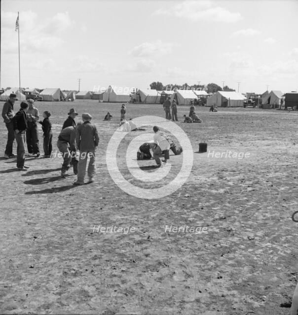 Marble time in FSA migratory labor camp, near Calipatria, Imperial Valley, CA, 1939. Creator: Dorothea Lange.