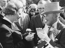 Margaret Thatcher presented with a carnation by Ken Bailey, Bournemouth, 24th March 1980. Creator: Unknown