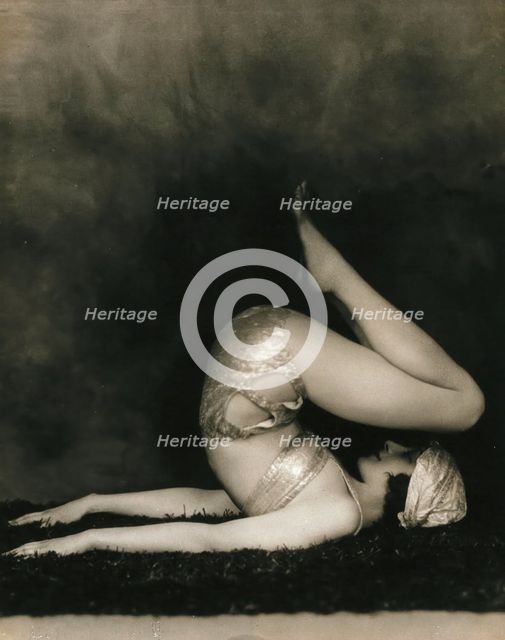 Marguerite Agniel posing with her back arched and feet in the air, wearing a two-piece cos..., 1929. Creator: Unknown.