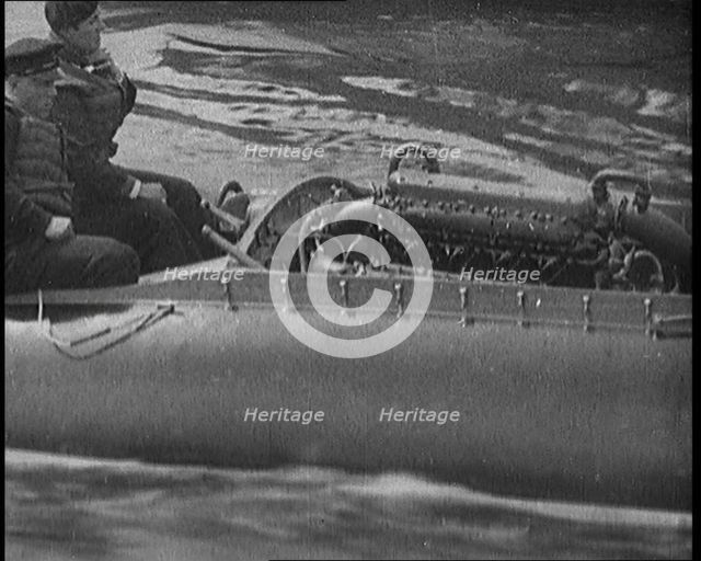 Marion Barbara 'Joe' Carstairs on a Speedboat with a Male Civilian Passenger, 1920. Creator: British Pathe Ltd.