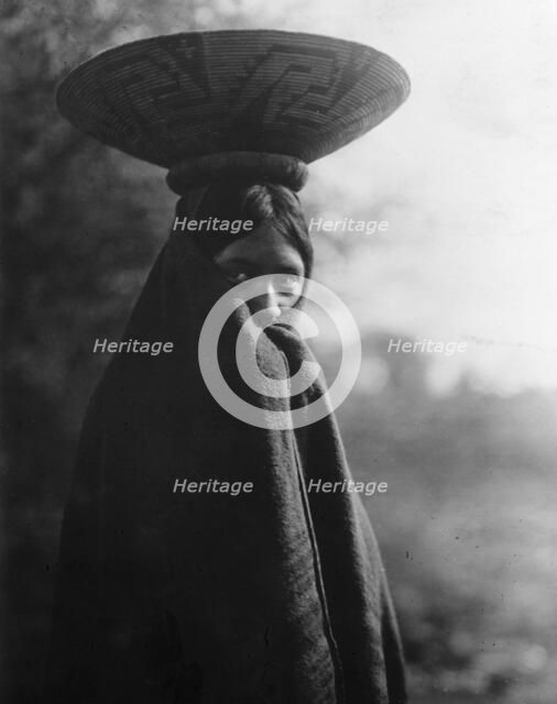 Maricopa girl, half-length portrait, standing, facing slightly right, wrapped in blanket..., c1907. Creator: Edward Sheriff Curtis.