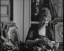 Mary Pickford Talking and Sitting Amongst Flowers in Paris, 1920. Creator: British Pathe Ltd